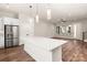 A modern kitchen has stainless steel appliances, a center island with white countertop, and pendant lighting at 437 Nathaniel Way # Brx0034, Charlotte, NC 28213