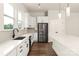 A modern kitchen features a stainless steel refrigerator and white countertops at 437 Nathaniel Way # Brx0034, Charlotte, NC 28213