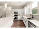 A white kitchen features stainless steel appliances and a kitchen island at 437 Nathaniel Way # Brx0034, Charlotte, NC 28213