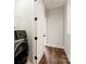 A compact laundry room features modern machines, access to another room, and overhead lighting at 437 Nathaniel Way # Brx0034, Charlotte, NC 28213