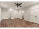 Spacious living room with wood floors, a ceiling fan, and access to stairs and a bathroom at 437 Nathaniel Way # Brx0034, Charlotte, NC 28213