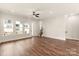 A bright living room showcases hardwood floors, a ceiling fan, and windows looking outside at 437 Nathaniel Way # Brx0034, Charlotte, NC 28213