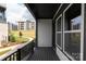 Balcony featuring gray siding and flooring, with a view of nearby building and landscaping at 437 Nathaniel Way # Brx0034, Charlotte, NC 28213