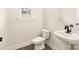 Powder room showcasing pedestal sink, elongated toilet and wood look flooring at 441 Nathaniel Way # Brx0035, Charlotte, NC 28213