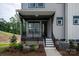 Inviting front porch with black railings and landscaping at 441 Nathaniel Way # Brx0035, Charlotte, NC 28213