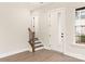 Hallway showing stairs to upper floor with a window, white walls, and a door to outside at 441 Nathaniel Way # Brx0035, Charlotte, NC 28213