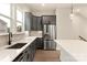 Bright kitchen features gray cabinetry, stainless steel appliances and white quartz countertops at 441 Nathaniel Way # Brx0035, Charlotte, NC 28213