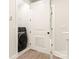 Laundry room featuring a front loading washer, folding door, and neutral flooring at 441 Nathaniel Way # Brx0035, Charlotte, NC 28213