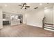 Spacious living area features hardwood floors, gray cabinets, stainless steel appliances, and staircase at 441 Nathaniel Way # Brx0035, Charlotte, NC 28213