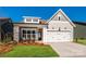 Gray exterior with white trim, stone accents, and a two-car garage at 1110 Lowland Way, Waxhaw, NC 28173