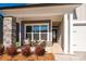 Cozy front porch with wicker chairs and a stone column at 1110 Lowland Way, Waxhaw, NC 28173