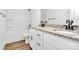Bathroom featuring a double sink, white cabinets, granite counters, and a bath with shower at 4122 Old Monroe Marshville Rd, Wingate, NC 28174