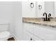 Bright bathroom features a white vanity with granite countertop and modern fixtures and a toilet at 4122 Old Monroe Marshville Rd, Wingate, NC 28174