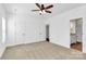 Spacious bedroom features a ceiling fan, carpet, and convenient access to an adjacent bathroom at 4122 Old Monroe Marshville Rd, Wingate, NC 28174