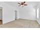 Cozy bedroom features a ceiling fan, carpet, and a large closet for storage at 4122 Old Monroe Marshville Rd, Wingate, NC 28174