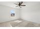 Inviting bedroom with natural light from the window, plus a ceiling fan and carpet at 4122 Old Monroe Marshville Rd, Wingate, NC 28174