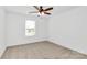 Bright bedroom with neutral carpet, ceiling fan and a large window offering natural light at 4122 Old Monroe Marshville Rd, Wingate, NC 28174