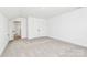 Clean, well-lit bedroom with neutral carpet, double closet, and a crisp, white interior at 4122 Old Monroe Marshville Rd, Wingate, NC 28174