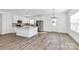 Modern kitchen with stainless steel appliances, white cabinetry, and large granite island at 4122 Old Monroe Marshville Rd, Wingate, NC 28174