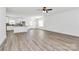 Bright open-concept living room with wood floors seamlessly connecting to the modern kitchen at 4122 Old Monroe Marshville Rd, Wingate, NC 28174