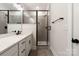 Modern bathroom featuring sleek black hardware, glass-enclosed shower with tile surround, and a spacious vanity at 428 Nathaniel Way # Brx0044, Charlotte, NC 28213