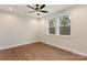 Bright bedroom boasts gleaming hardwood floors, neutral walls, ceiling fan, and large windows with backyard views at 428 Nathaniel Way # Brx0044, Charlotte, NC 28213