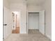 This bedroom features a walk-in closet with double doors, carpet, and a neutral wall at 428 Nathaniel Way # Brx0044, Charlotte, NC 28213