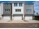 Rear exterior view of modern townhomes with garage and new construction at 428 Nathaniel Way # Brx0044, Charlotte, NC 28213