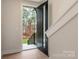 Bright foyer with a view of the front door and a staircase with wood treads and white risers at 428 Nathaniel Way # Brx0044, Charlotte, NC 28213