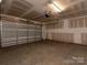 An empty garage with a garage door and concrete flooring at 428 Nathaniel Way # Brx0044, Charlotte, NC 28213