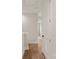 This hallway features wood look flooring and white doors and trim at 428 Nathaniel Way # Brx0044, Charlotte, NC 28213