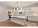 Beautiful kitchen with center island, white cabinetry, modern light fixtures, and stainless steel appliances at 428 Nathaniel Way # Brx0044, Charlotte, NC 28213