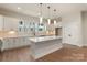 Bright kitchen features a large island, recessed lighting, stainless steel appliances, and modern white cabinetry at 428 Nathaniel Way # Brx0044, Charlotte, NC 28213