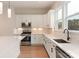 Bright kitchen featuring white cabinets, quartz countertops, tile backsplash, and stainless steel appliances at 428 Nathaniel Way # Brx0044, Charlotte, NC 28213