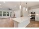 Open floor plan featuring a kitchen with an island and a living area with large windows and modern lighting at 428 Nathaniel Way # Brx0044, Charlotte, NC 28213