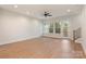 Bright living room with neutral walls, a ceiling fan, hardwood floors, and an exterior glass door to a small deck at 428 Nathaniel Way # Brx0044, Charlotte, NC 28213
