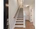 A staircase with wood treads, white risers, and railing that leads to the upper level of the home at 428 Nathaniel Way # Brx0044, Charlotte, NC 28213