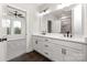 Well-lit bathroom with double vanity, modern fixtures, and a view into the adjacent bedroom at 432 Nathaniel Way # Brx0043, Charlotte, NC 28213