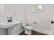 Stylish half bathroom featuring a pedestal sink, modern toilet, and a window at 432 Nathaniel Way # Brx0043, Charlotte, NC 28213