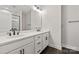 Bathroom with double sinks, a large mirror, modern fixtures, and walk-in shower at 432 Nathaniel Way # Brx0043, Charlotte, NC 28213