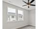 Bright bedroom with two large windows offering neighborhood views and a modern ceiling fan at 432 Nathaniel Way # Brx0043, Charlotte, NC 28213