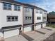 Back exterior view of a gray townhome with a drive under garage at 432 Nathaniel Way # Brx0043, Charlotte, NC 28213