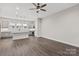 Open living room with ceiling fan showcasing kitchen in the background at 432 Nathaniel Way # Brx0043, Charlotte, NC 28213
