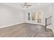 Bright living room with hardwood floors, ceiling fan, and exterior access to a balcony at 432 Nathaniel Way # Brx0043, Charlotte, NC 28213