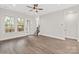 Bright living room with wood-style floors, large windows offering natural light, and access to a balcony at 432 Nathaniel Way # Brx0043, Charlotte, NC 28213