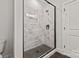 Modern glass shower featuring elegant white marble-patterned tile and matte black hardware at 432 Nathaniel Way # Brx0043, Charlotte, NC 28213