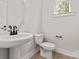 This well-lit powder room features a pedestal sink and modern fixtures at 436 Nathaniel Way # Brx0042, Charlotte, NC 28213