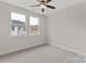 A bedroom features two large windows with a ceiling fan at 436 Nathaniel Way # Brx0042, Charlotte, NC 28213