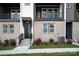 Charming brick townhome exterior with a covered entrance and black accents at 436 Nathaniel Way # Brx0042, Charlotte, NC 28213