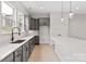 Bright kitchen boasts gray cabinets, stainless steel appliances, quartz countertops, and a large island at 436 Nathaniel Way # Brx0042, Charlotte, NC 28213